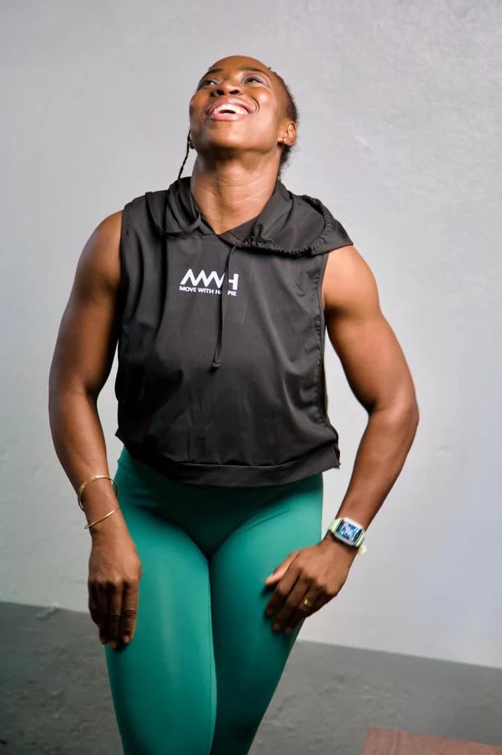 Happie in an MWH training top, head back, laughing